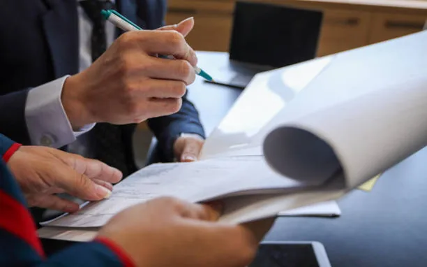 Two people signing a document